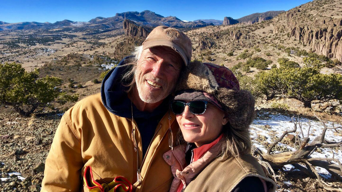 Michael and KimAnna enjoying the breathtaking view from the ranch's peak, surrounded by majestic mountains
