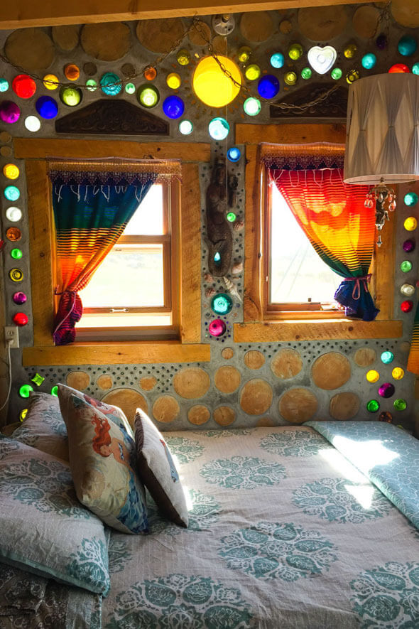 Experience the magic of the Mermaid Cottage with a comfortable queen sized bed and a kaleidoscope of light illuminating from bottle walls