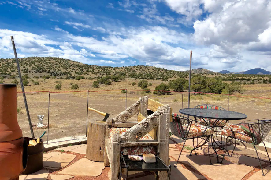 Experience ultimate relaxation on a patio with a  chimenea, table and chairs, and awesome views