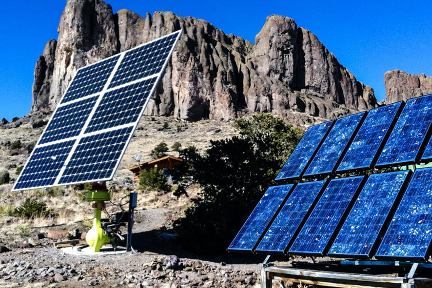 Witness the perfect fusion of renewable energy as solar panels grace the serene beauty of a mountainous terrain