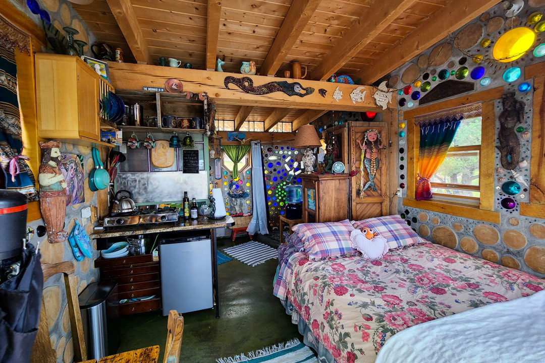 Whimsical mermaid-themed tiny house with all the essentials: enchanting ambiance, cozy queen bed, kitchenette, full bathroom