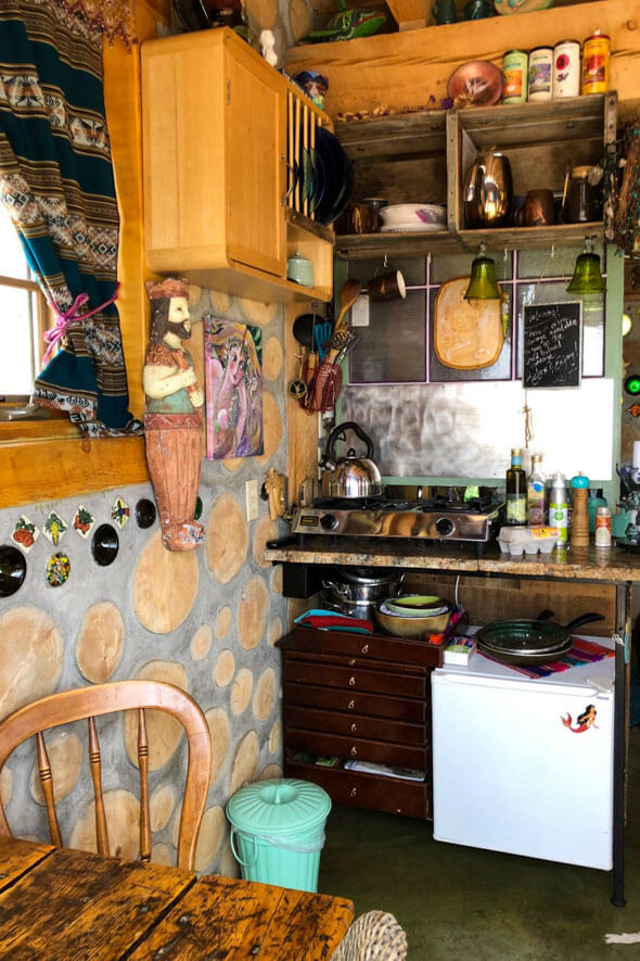 The Mermaid Cottage features a charming kitchen and dining area with a stove, sink, and table, perfect for cooking delicious meals