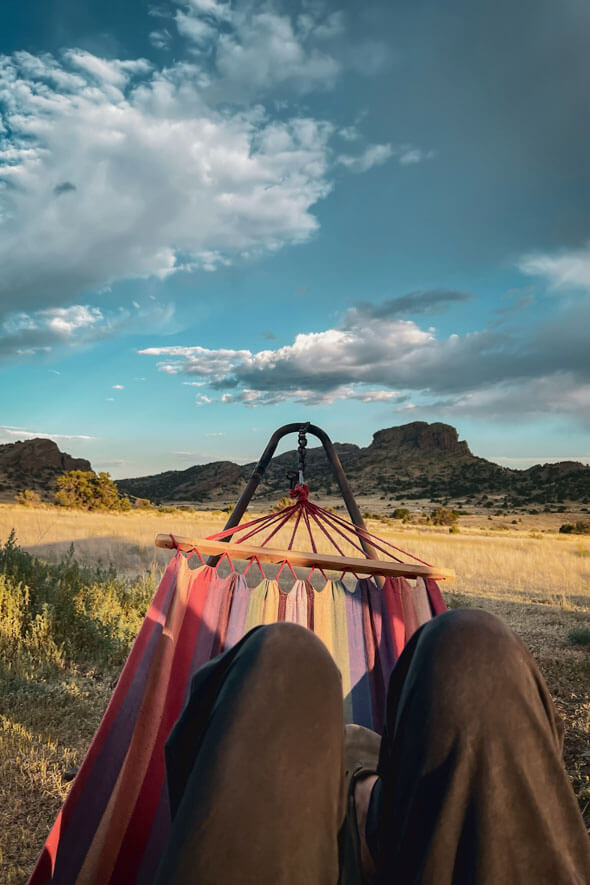 Picture-perfect moment: someone lounging in a hammock, gazing at stunning mountains