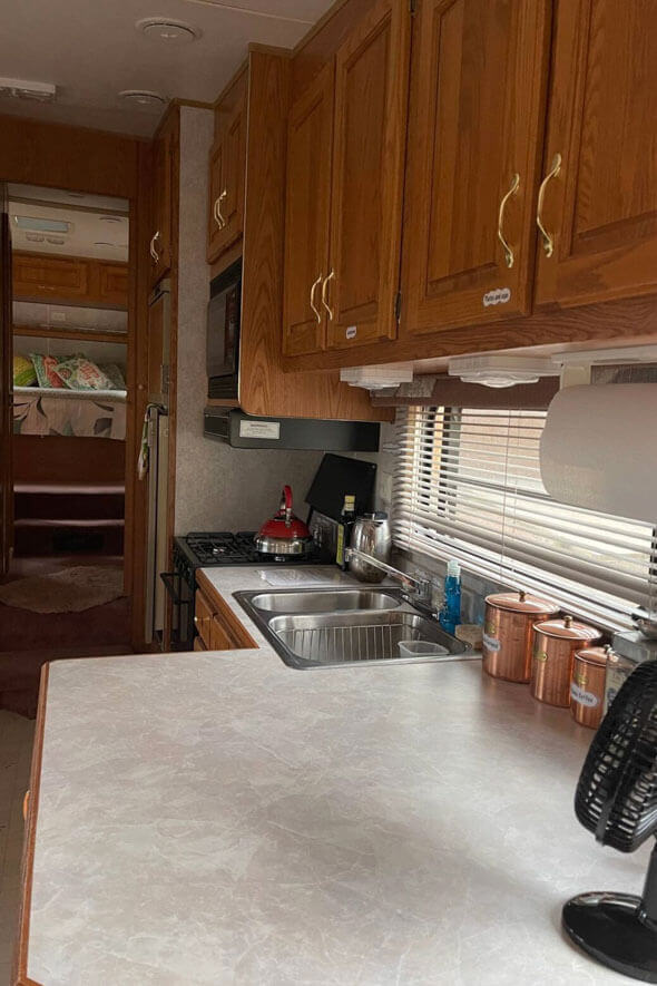 RV kitchen with a convenient sink and a handy microwave for quick and easy meals on the go