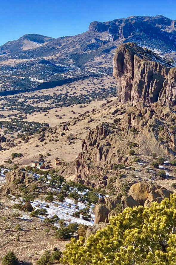 Stunning landscape of mountains and desert with a snowy touch at Angel Rock Ranch in the Summer Coon La Ventana Geologic Area, Colorado